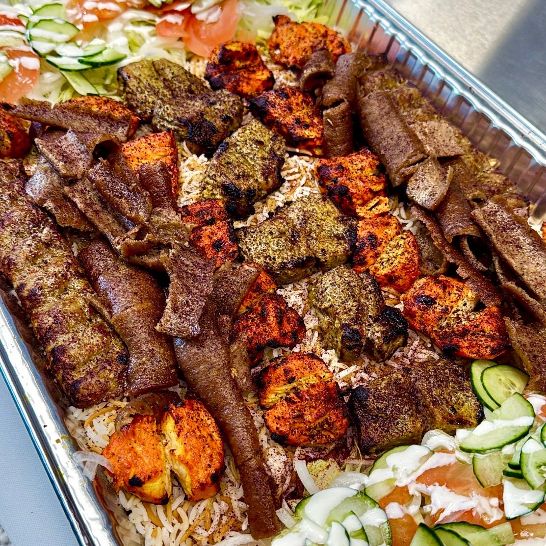 Family platter of mixed kabobs, gyro and rice
